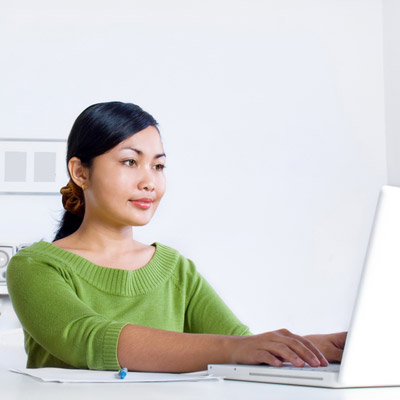 A colour photo of a person working on a laptop symbolising an Oakford Group stakeholder